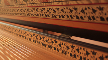 Thumbnail depicting a portion of inside a harpsichord. Strings and some decoration visible.